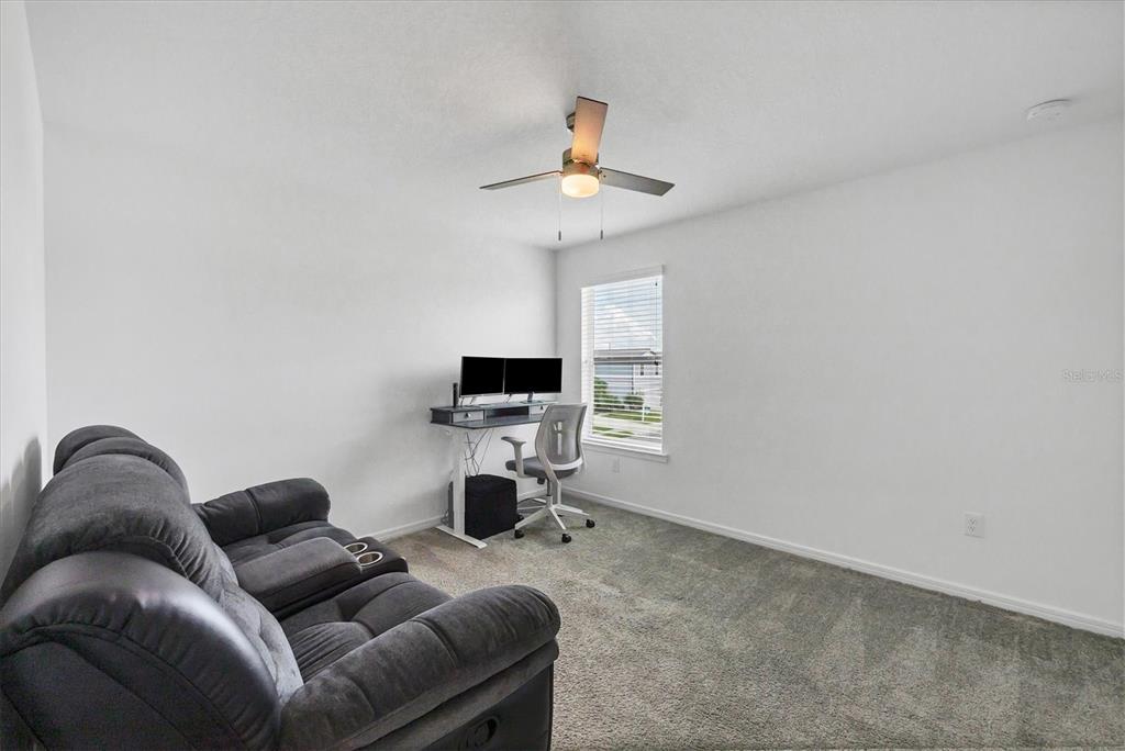 9528 Lamine Way Parrish, FL 34219 - Photo 32 of 58 a living room with furniture a ceiling fan and a window