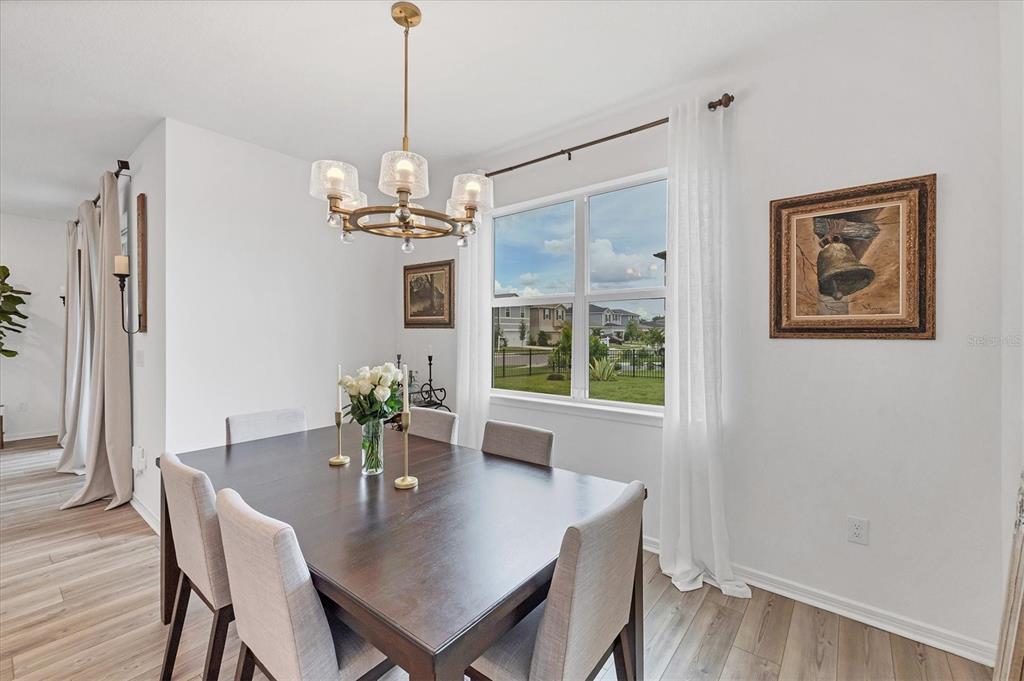 9528 Lamine Way Parrish, FL 34219 - Photo 4 of 58 a view of a dining room with furniture window and wooden floor