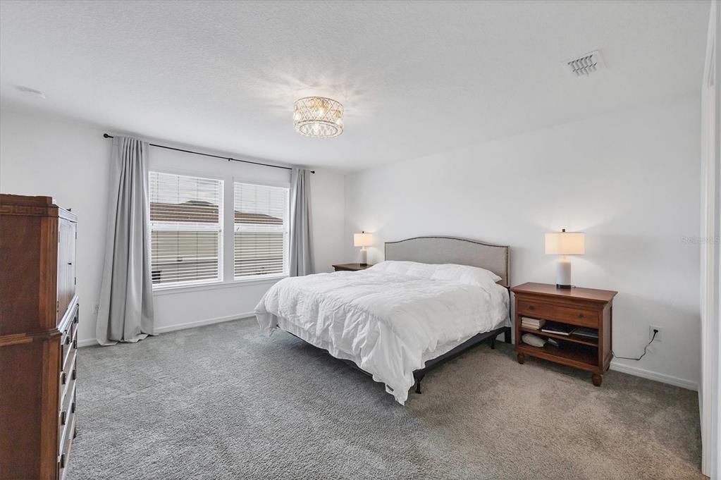 9528 Lamine Way Parrish, FL 34219 - Photo 5 of 58 a spacious bedroom with a bed and a window