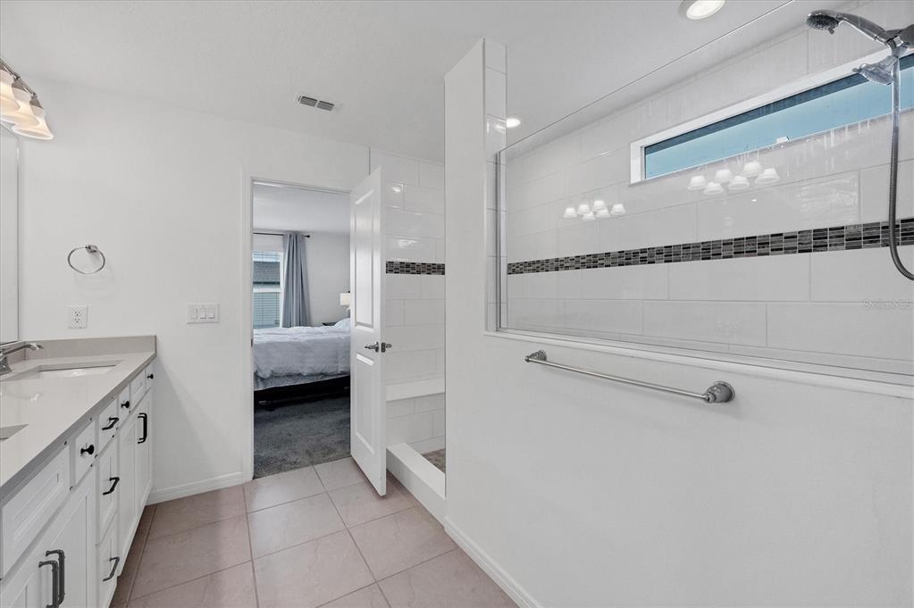 9528 Lamine Way Parrish, FL 34219 - Photo 7 of 58 a bathroom with a double vanity sink and mirror