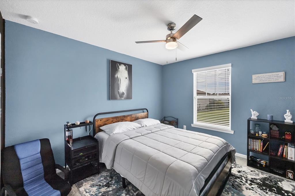 9528 Lamine Way Parrish, FL 34219 - Photo 8 of 58 a bedroom with a bed and wooden floor