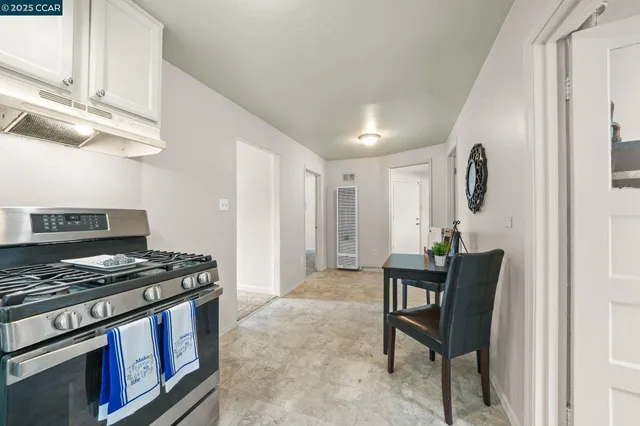 a kitchen with stainless steel appliances granite countertop a stove and a refrigerator