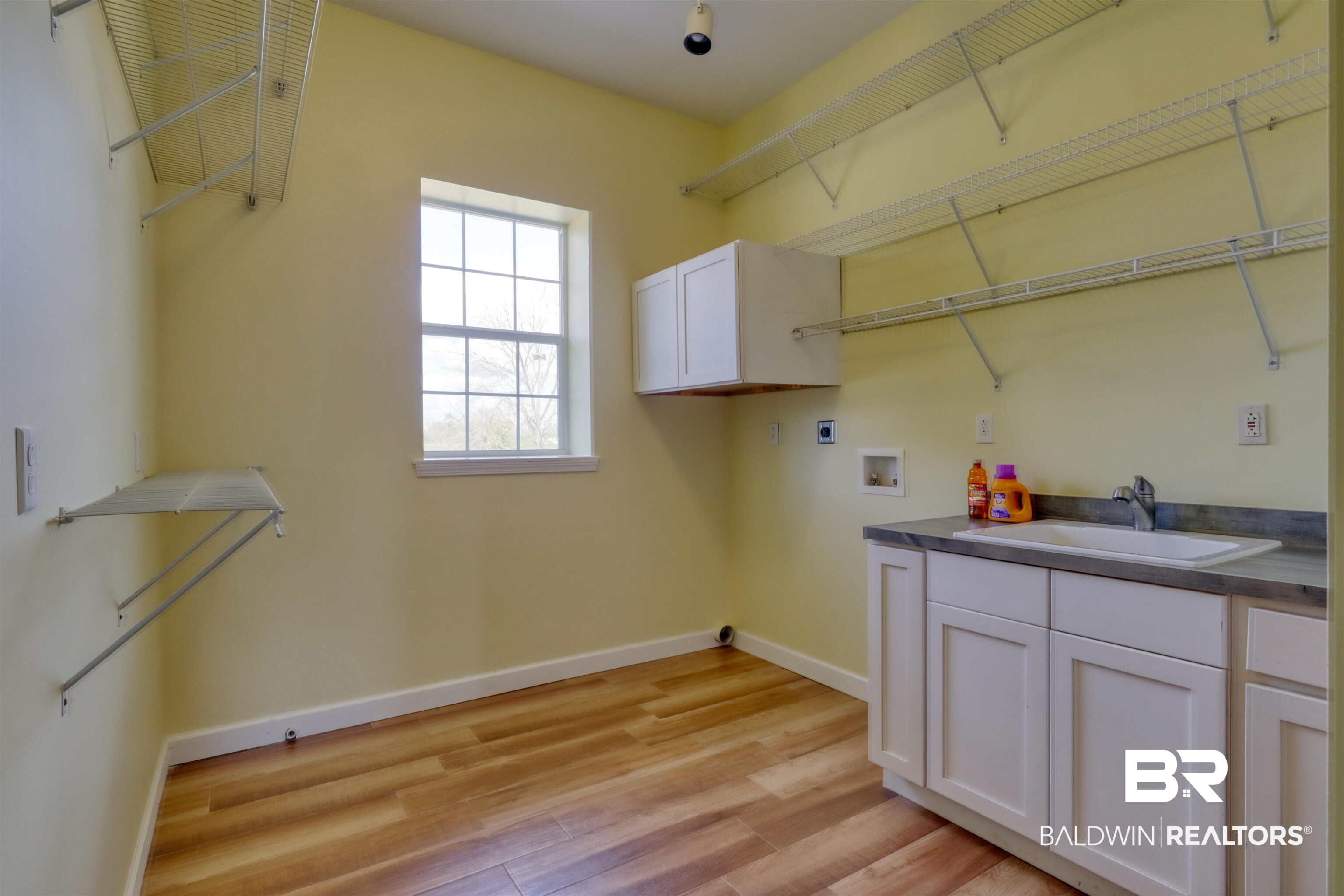 28461 Gardner Road Elberta, AL 36530 - Photo 7 of 46 Laundry area featuring cabinet space, washer hookup, and light wood-style flooring