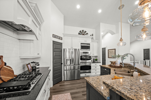 4077 Rons Court Riverton, UT 84096 - Photo 7 of 48 This beautiful chef's kitchen offers the perfect blend of style and function, creating a welcoming space for family and friends to gather.