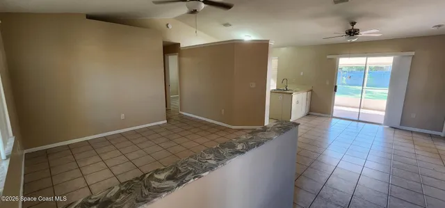 an empty room with wooden floor and natural light