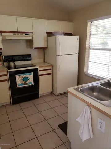 a kitchen with a stove a refrigerator and a sink