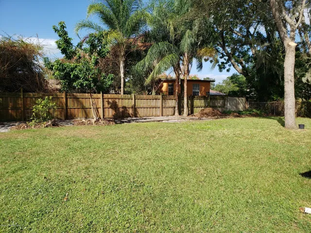 a view of a house with a yard porch and sitting area