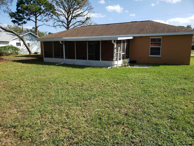a view of house with yard