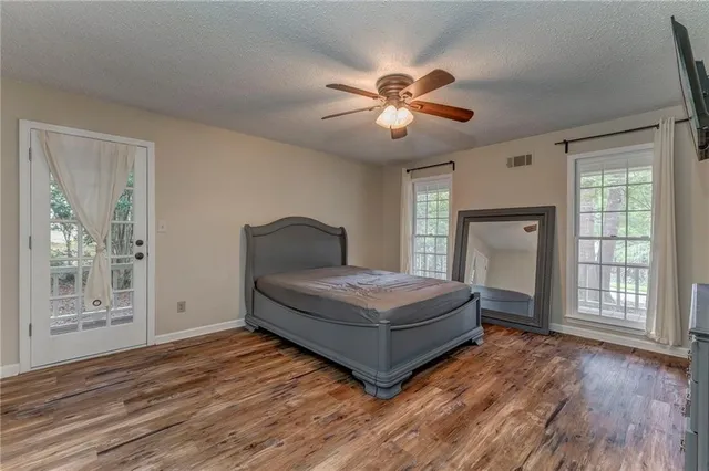 a living room with a bed furniture and a window