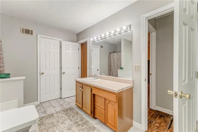 a bathroom with a sink a mirror and a shower