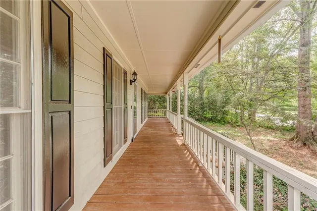 a view of a porch with wooden floor and stairs