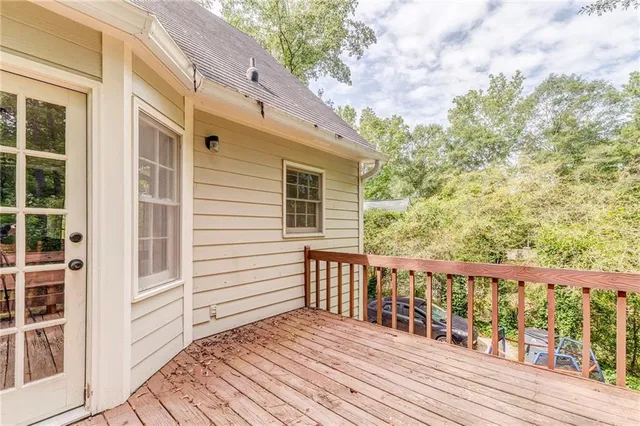 a balcony with wooden floor and fence