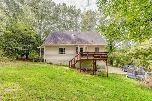 a view of a house with a yard and sitting area