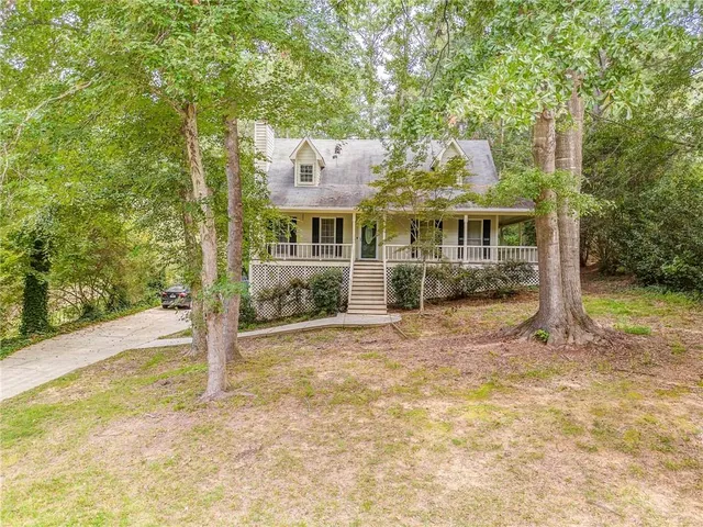 a view of a house with a backyard and balcony