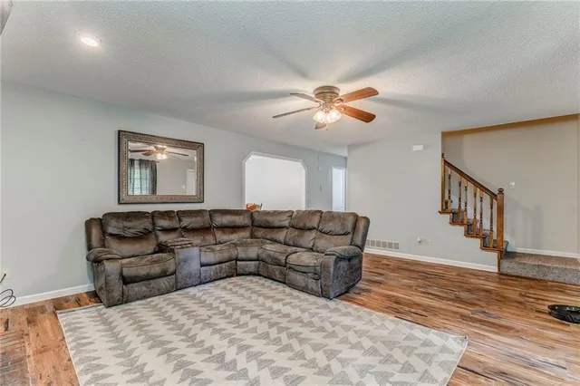 a living room with furniture and wooden floor