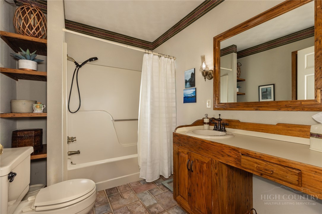 1335 Shingle Gap Road Purlear, NC 28665 - Photo 28 of 49 a bathroom with a granite countertop sink toilet tub and shower