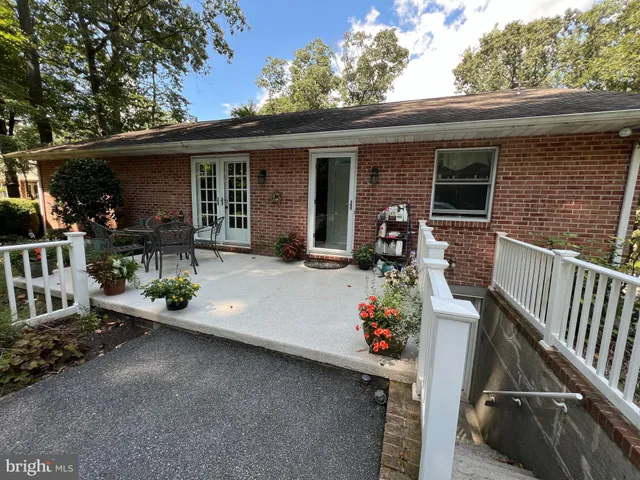 a front view of a house with sitting area