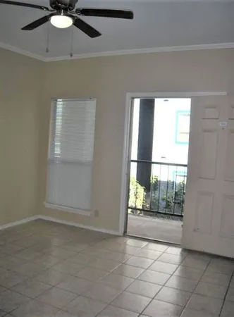 an empty room with windows and entrance