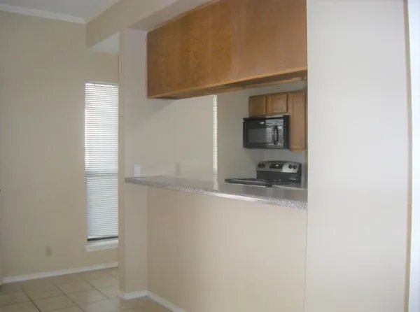 a hallway with a sink and a mirror
