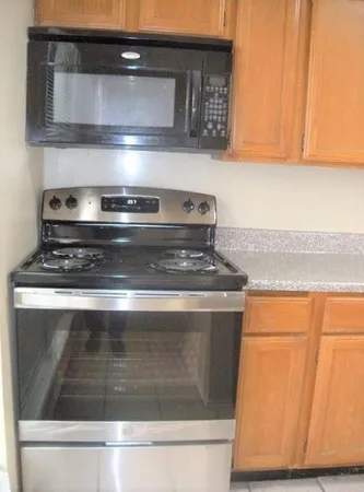 a stove top oven sitting inside of a kitchen
