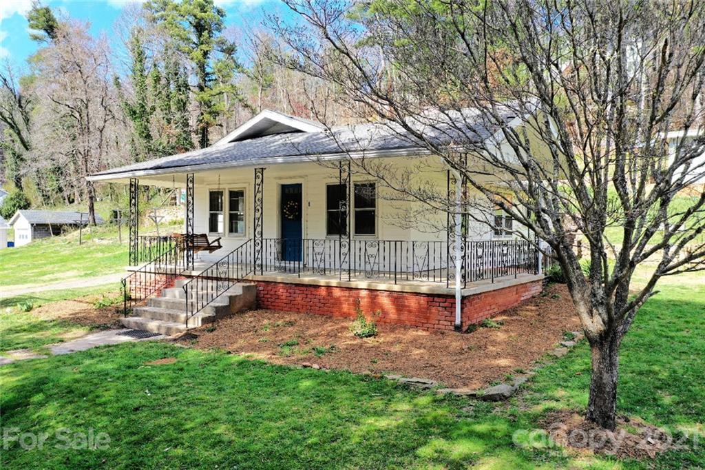 1 Sycamore Street Asheville, NC 28804 - Photo 2 of 46 a front view of a house with a yard table and chairs