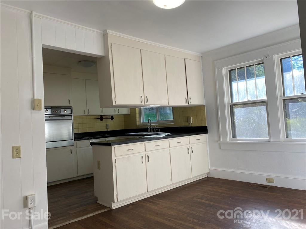 1 Sycamore Street Asheville, NC 28804 - Photo 12 of 46 a kitchen with a sink and cabinets