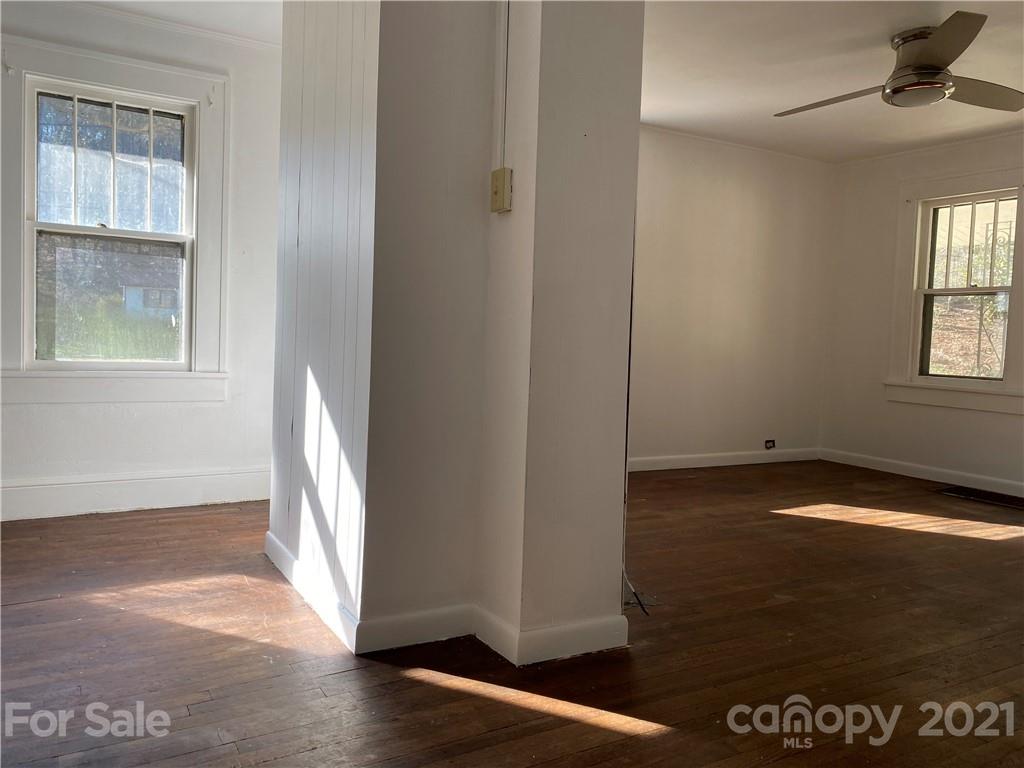 1 Sycamore Street Asheville, NC 28804 - Photo 13 of 46 a view of an empty room with wooden floor and a window