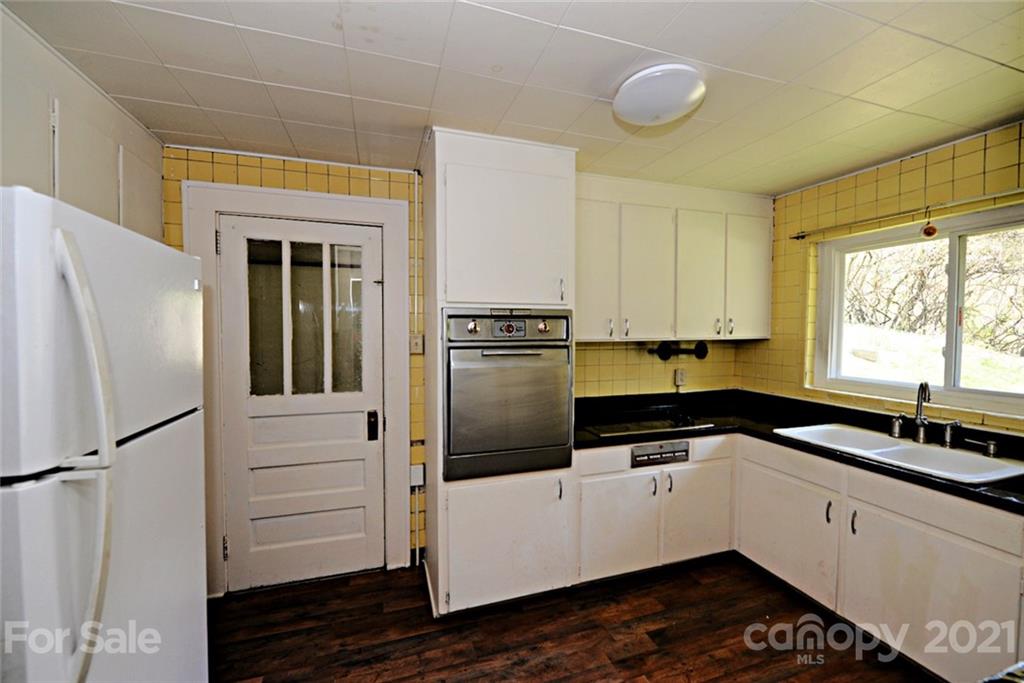 1 Sycamore Street Asheville, NC 28804 - Photo 15 of 46 a kitchen with a refrigerator and a sink