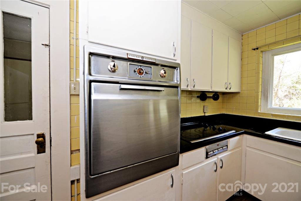 1 Sycamore Street Asheville, NC 28804 - Photo 16 of 46 a kitchen with a refrigerator and a stove