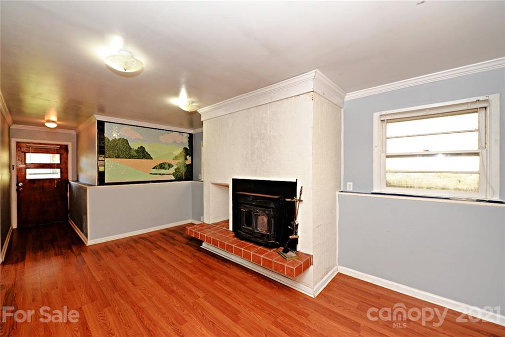 1 Sycamore Street Asheville, NC 28804 - Photo 29 of 46 a view of a livingroom with wooden floor and a fireplace