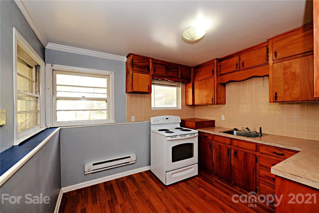 1 Sycamore Street Asheville, NC 28804 - Photo 32 of 46 a kitchen with stainless steel appliances a stove a sink and a microwave