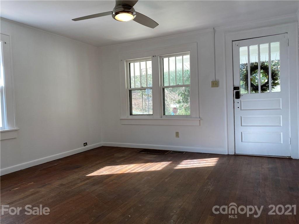 1 Sycamore Street Asheville, NC 28804 - Photo 10 of 46 an empty room with wooden floor and windows
