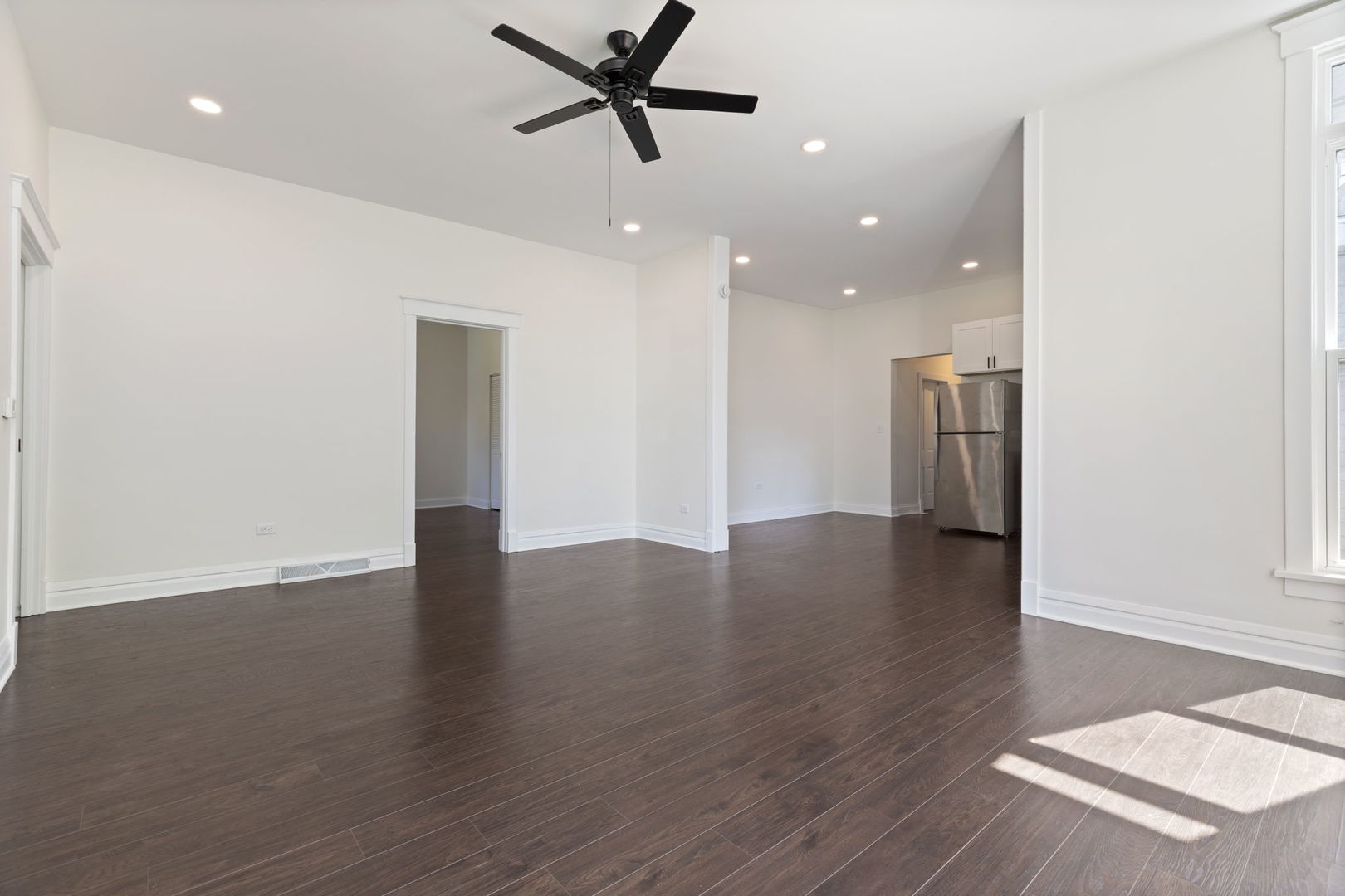718 Sycamore Street Ottawa, IL 61350 - Photo 5 of 27 a view of an empty room with wooden floor and a window