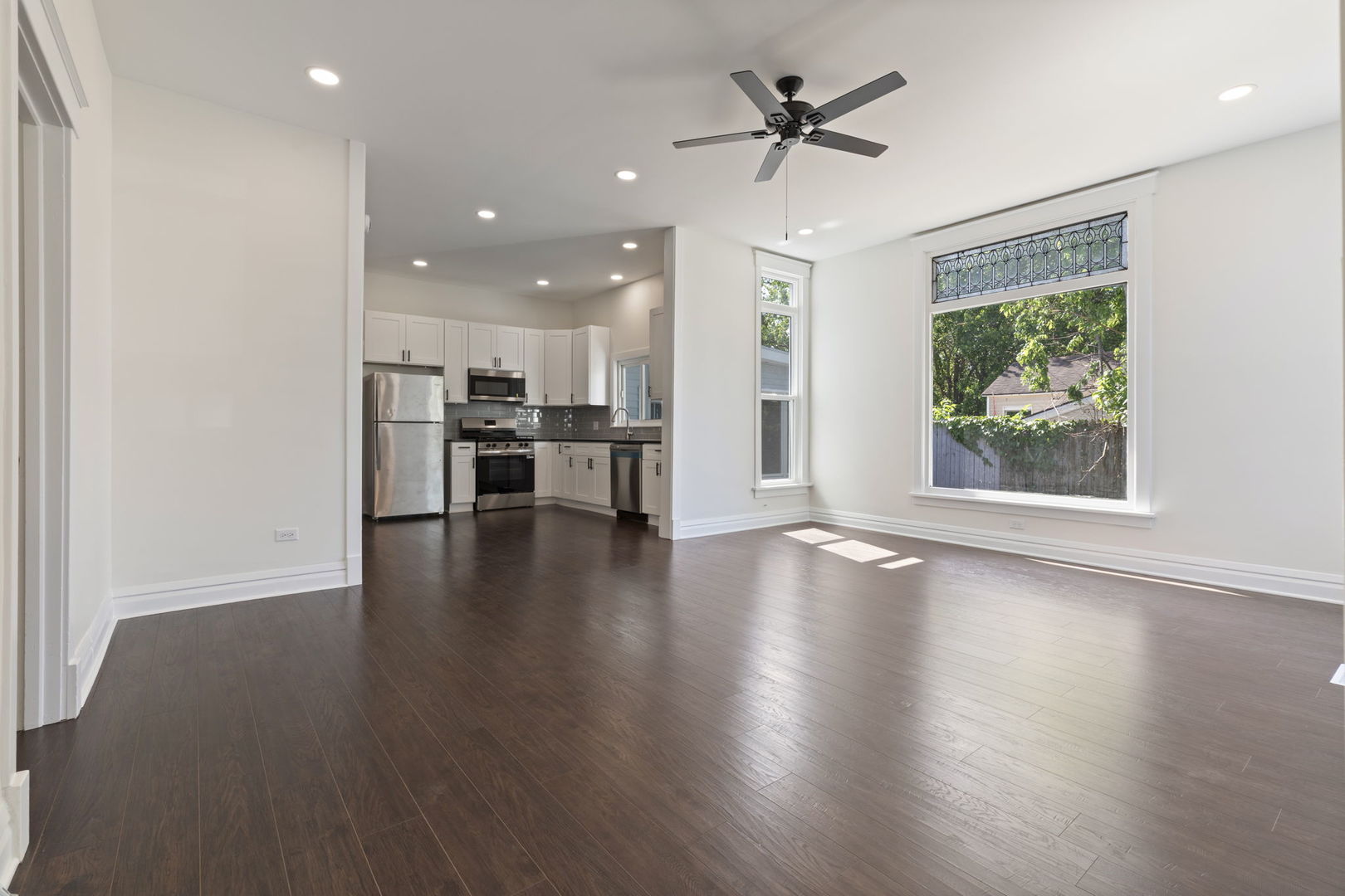 718 Sycamore Street Ottawa, IL 61350 - Photo 8 of 27 a view of a kitchen with a stove wooden floor and a window