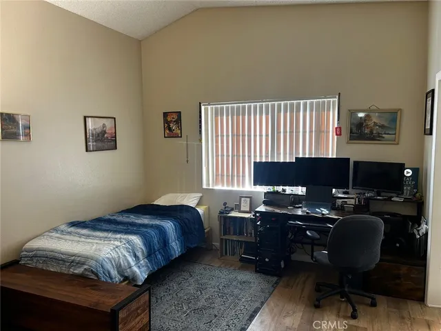 a bedroom with a bed and a desk