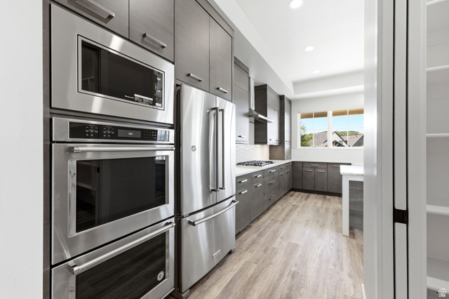 496 North Farmhouse Way, Unit 11 Midway, UT 84049 - Photo 18 of 50 Modern kitchen featuring stainless steel appliances, dark wood-finish cabinetry, light wood-finish flooring, white countertops, and recessed lighting