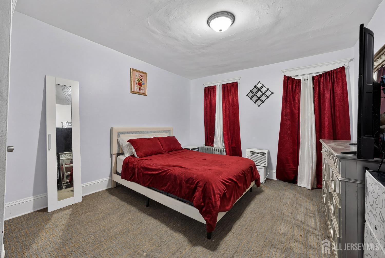 361 Prospect Street Perth Amboy, NJ 08861 - Photo 23 of 50 a bedroom with a bed and a flat screen tv