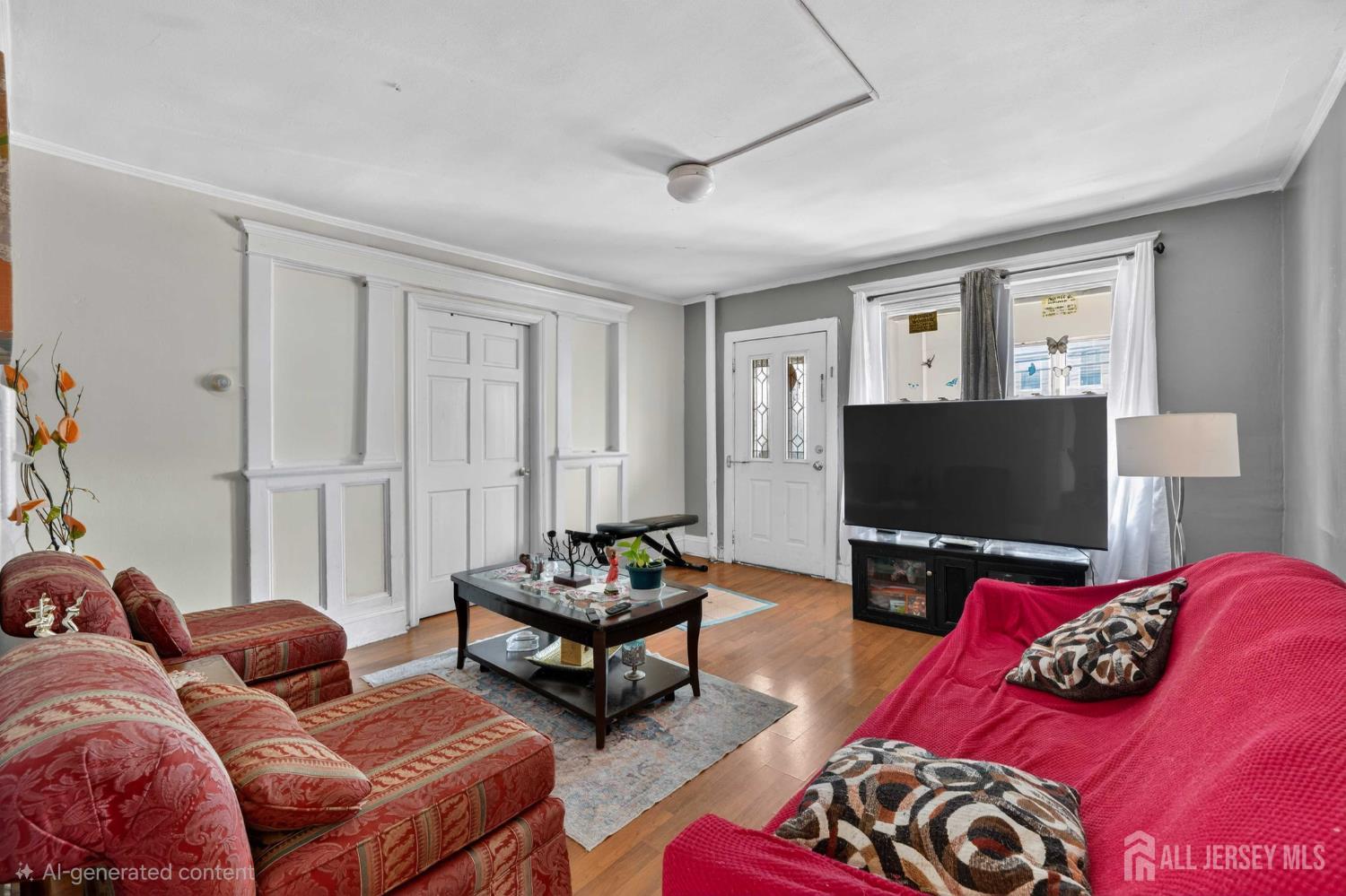 361 Prospect Street Perth Amboy, NJ 08861 - Photo 3 of 50 a living room with furniture a flat screen tv and a window