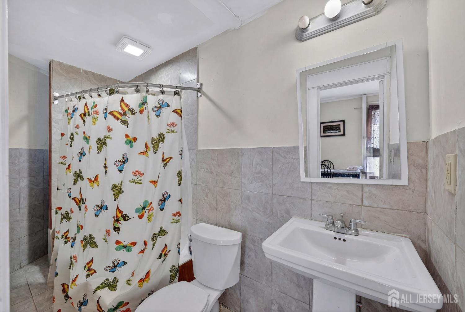 361 Prospect Street Perth Amboy, NJ 08861 - Photo 33 of 50 a bathroom with a sink and a mirror