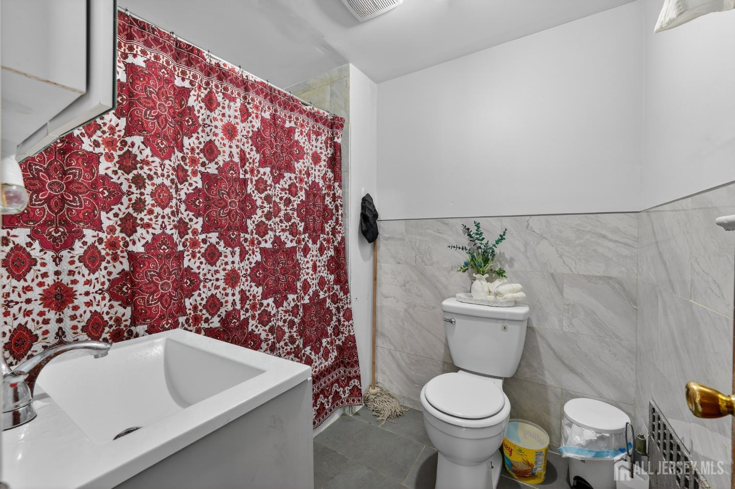 361 Prospect Street Perth Amboy, NJ 08861 - Photo 10 of 50 a white toilet sitting next to a bathroom sink