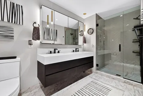a bathroom with a sink vanity and a mirror
