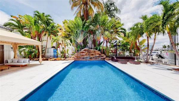 a swimming pool with outdoor seating and yard