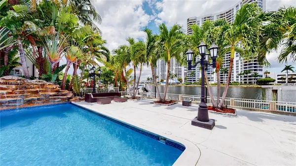 a swimming pool with outdoor seating and yard