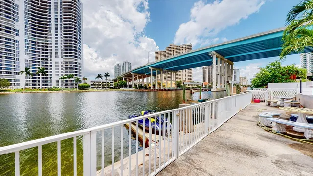 a balcony with wooden floor and lake view