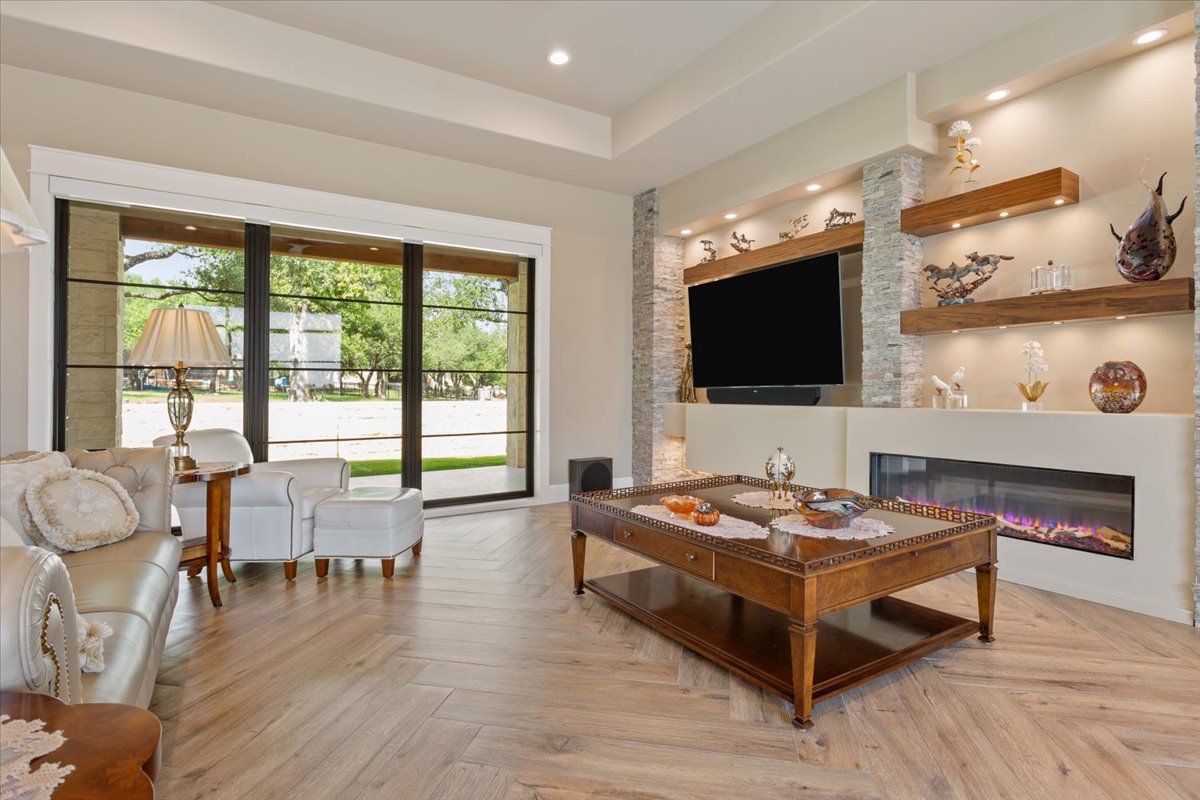 309 Highland Spring Lane Georgetown, TX 78633 - Photo 4 of 40 As you enter, you immediately take in the view of the heavily treed back yard. A propane fueled fireplace to the right with natural logs. Floating shelves are rich Walnut...