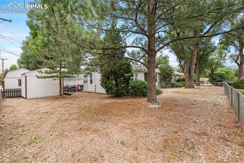 317 West Harrison Street Colorado Springs, CO 80907 - Photo 13 of 22 Fenced backyard with a shed (2 of the 3 units have sheds)