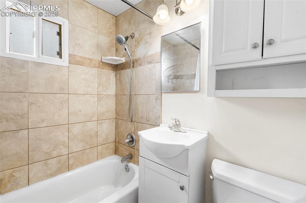 317 West Harrison Street Colorado Springs, CO 80907 - Photo 6 of 22 Full bath with shower / tub combination and vanity