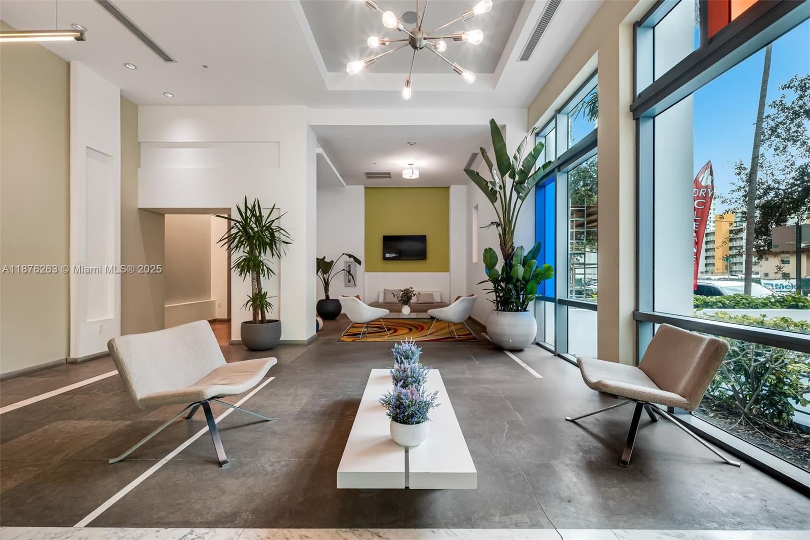 a living room with furniture and a chandelier