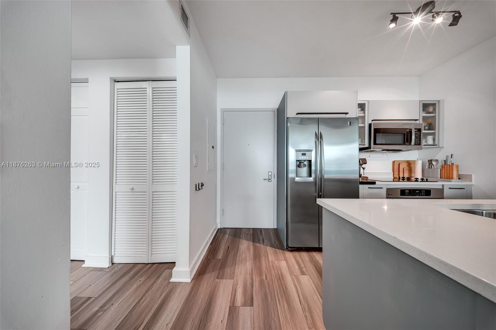 333 Northeast 24th Street, Unit 1111 Miami, FL 33137 - Photo 12 of 39 a kitchen with kitchen island a refrigerator stove and sink