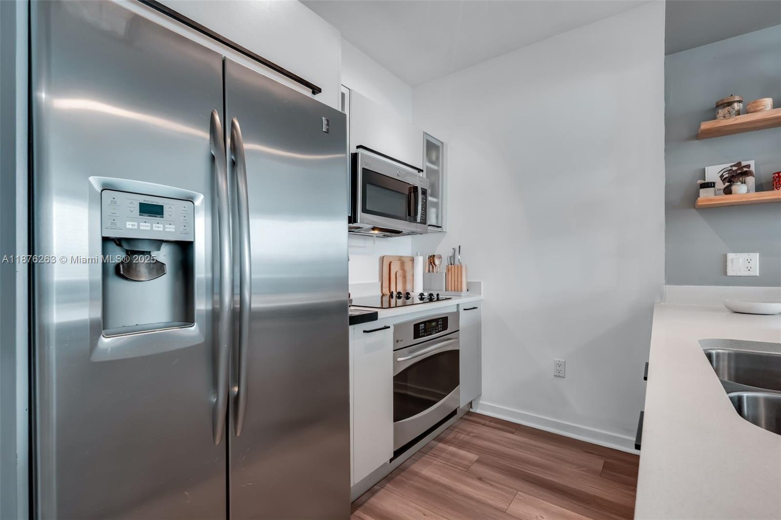 333 Northeast 24th Street, Unit 1111 Miami, FL 33137 - Photo 14 of 39 a kitchen with a refrigerator and a stove